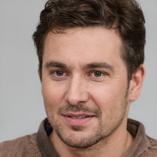 Joyful white adult male with short  brown hair and brown eyes