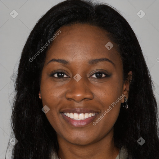 Joyful black young-adult female with long  black hair and brown eyes