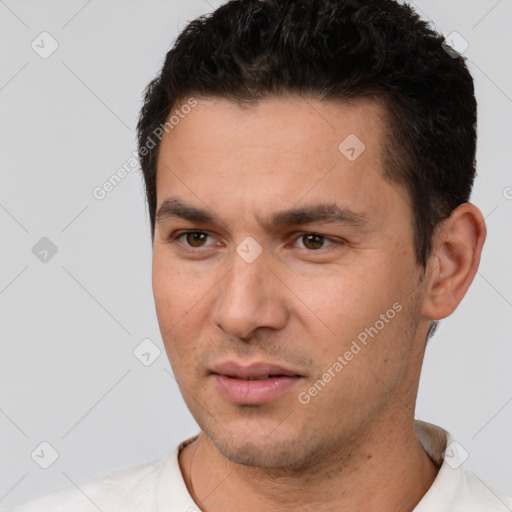 Joyful white young-adult male with short  black hair and brown eyes