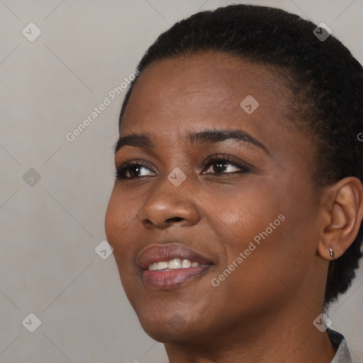 Joyful black young-adult female with short  black hair and brown eyes