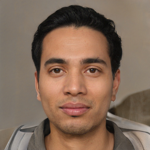 Joyful asian young-adult male with short  black hair and brown eyes