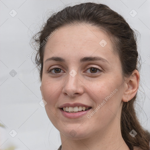 Joyful white young-adult female with long  brown hair and brown eyes