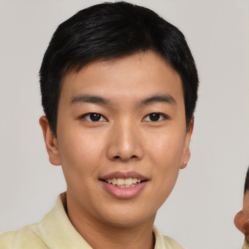 Joyful asian young-adult male with short  black hair and brown eyes