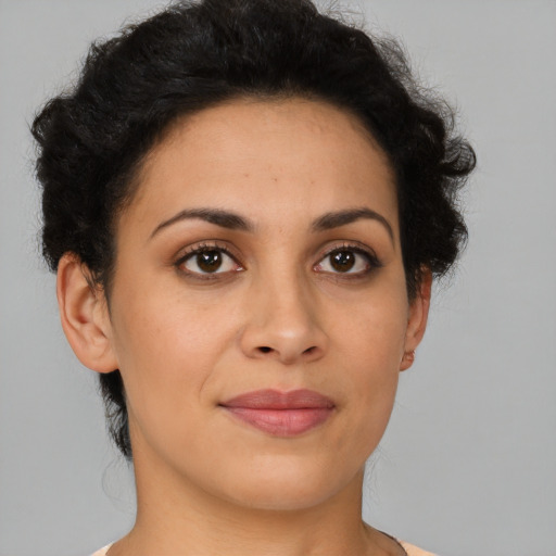 Joyful latino young-adult female with short  brown hair and brown eyes