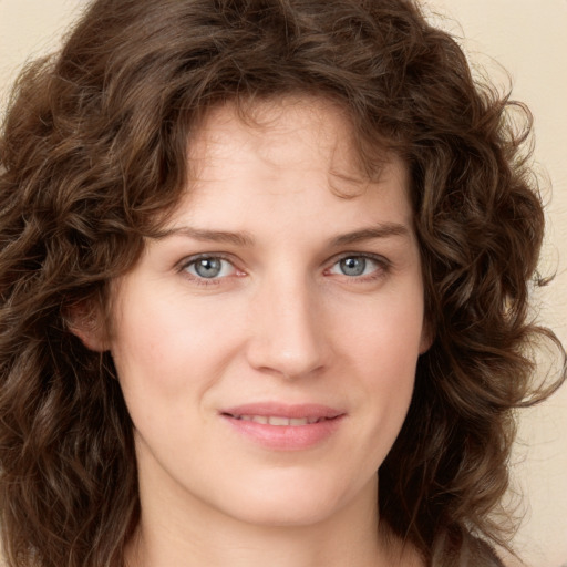 Joyful white young-adult female with long  brown hair and green eyes