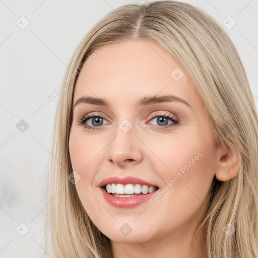 Joyful white young-adult female with long  brown hair and blue eyes