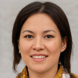 Joyful white young-adult female with medium  brown hair and brown eyes