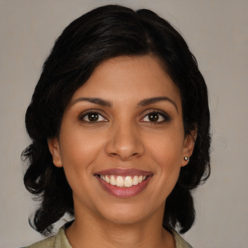 Joyful latino young-adult female with medium  black hair and brown eyes