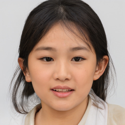 Joyful asian child female with medium  brown hair and brown eyes