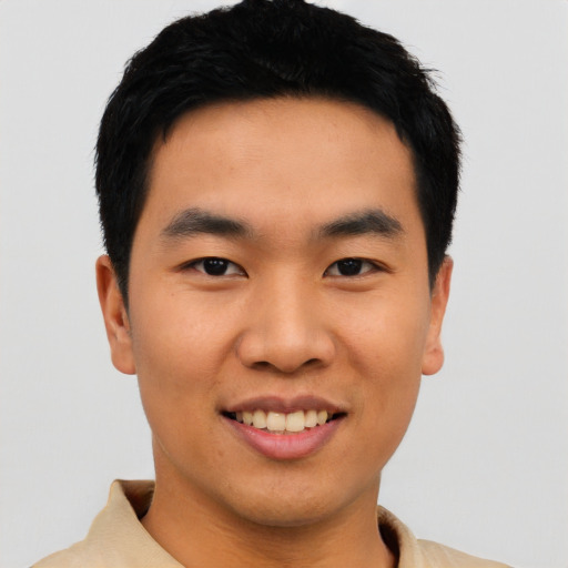 Joyful asian young-adult male with short  black hair and brown eyes