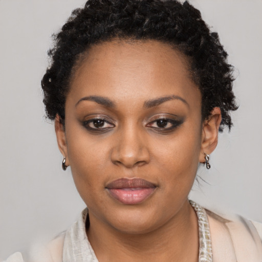 Joyful black young-adult female with short  black hair and brown eyes