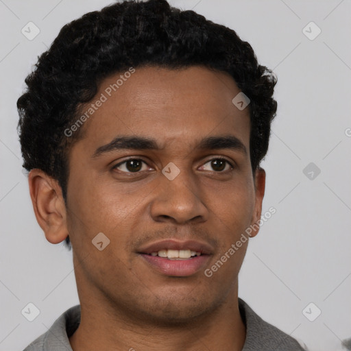 Joyful black young-adult male with short  brown hair and brown eyes