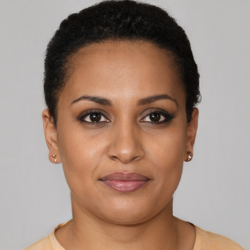 Joyful black young-adult female with short  brown hair and brown eyes