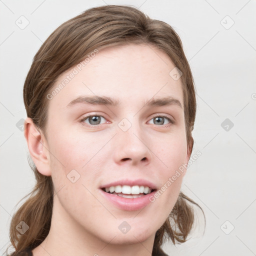 Joyful white young-adult female with long  brown hair and blue eyes