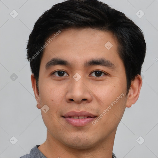 Joyful asian young-adult male with short  black hair and brown eyes