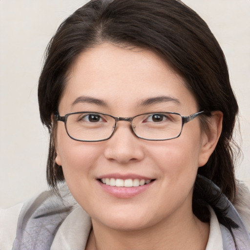 Joyful white young-adult female with medium  brown hair and brown eyes