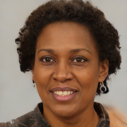 Joyful black adult female with short  brown hair and brown eyes