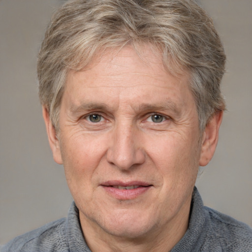 Joyful white middle-aged male with short  brown hair and grey eyes