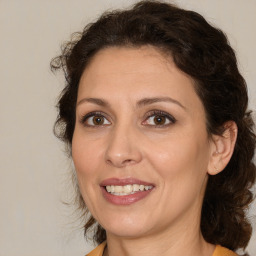 Joyful white adult female with medium  brown hair and brown eyes