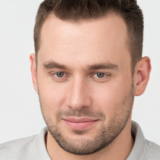 Joyful white young-adult male with short  brown hair and brown eyes