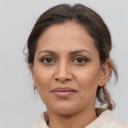 Joyful white adult female with medium  brown hair and brown eyes