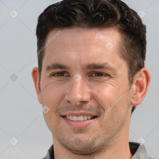 Joyful white adult male with short  brown hair and brown eyes