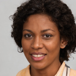 Joyful black young-adult female with long  brown hair and brown eyes