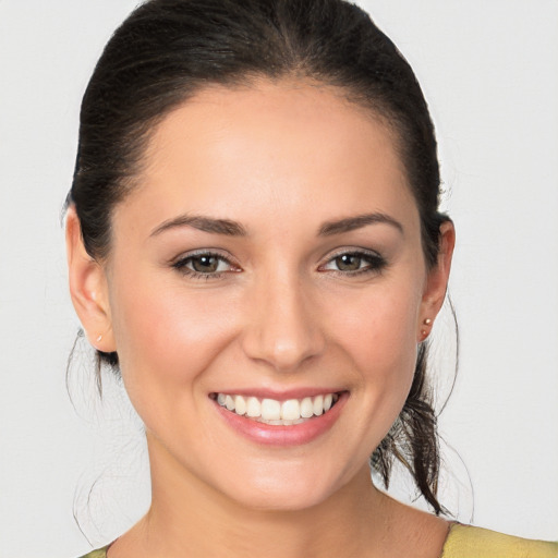 Joyful white young-adult female with medium  brown hair and brown eyes