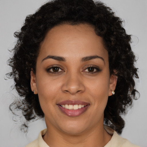 Joyful black young-adult female with medium  brown hair and brown eyes