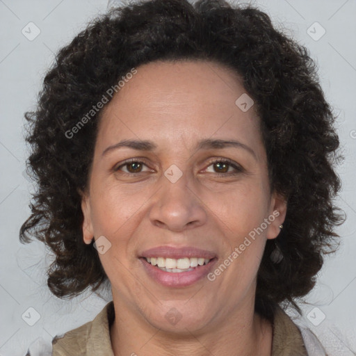 Joyful black adult female with long  brown hair and brown eyes