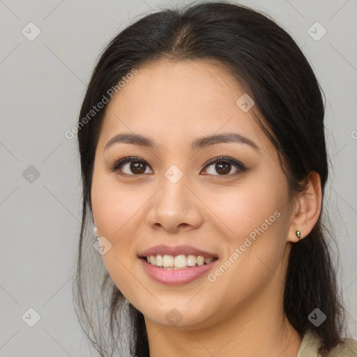 Joyful asian young-adult female with long  brown hair and brown eyes