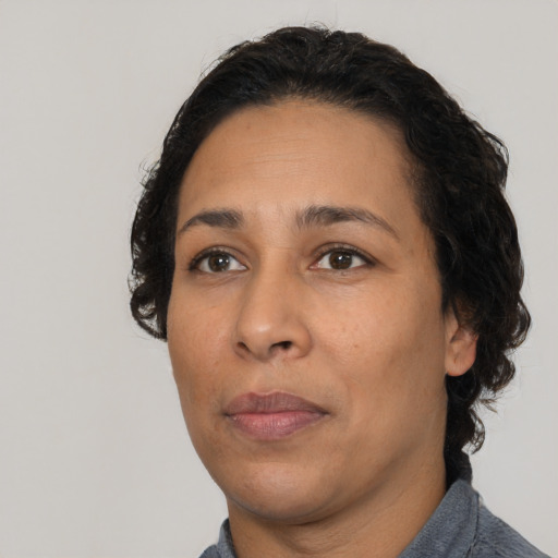 Neutral latino adult female with short  black hair and brown eyes