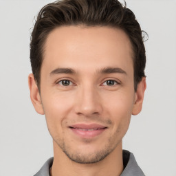 Joyful white young-adult male with short  brown hair and brown eyes