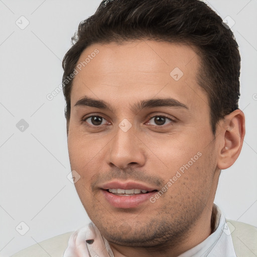 Joyful white young-adult male with short  brown hair and brown eyes