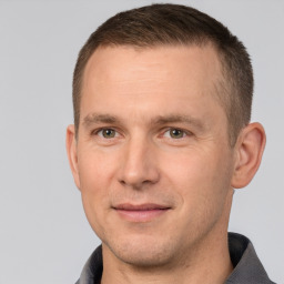 Joyful white adult male with short  brown hair and brown eyes