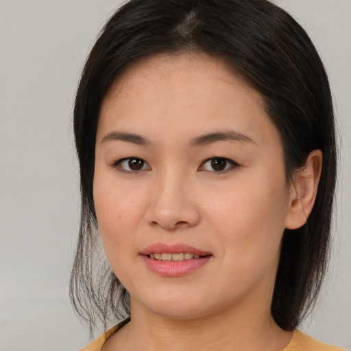 Joyful asian young-adult female with medium  brown hair and brown eyes