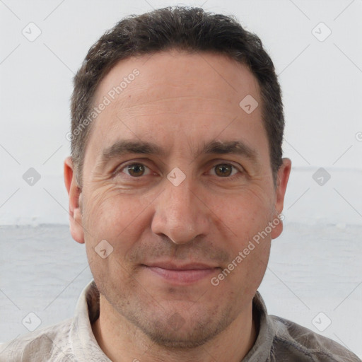 Joyful white adult male with short  brown hair and brown eyes