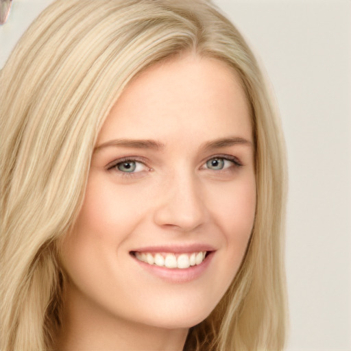 Joyful white young-adult female with long  blond hair and blue eyes