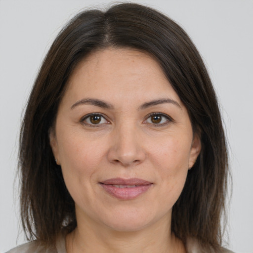 Joyful white adult female with medium  brown hair and brown eyes