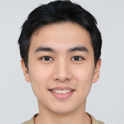 Joyful asian young-adult male with short  black hair and brown eyes