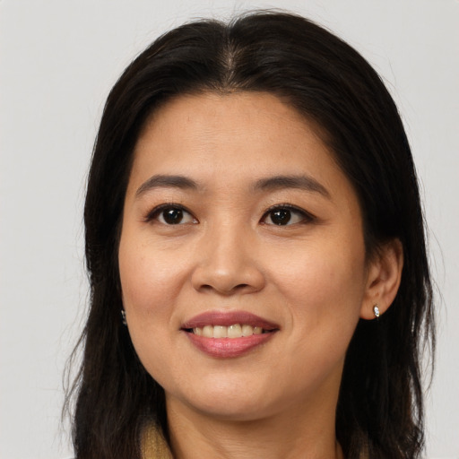 Joyful asian young-adult female with long  brown hair and brown eyes