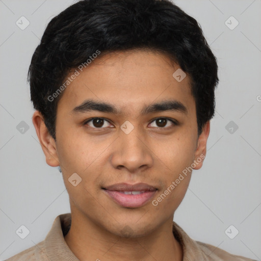 Joyful latino young-adult male with short  brown hair and brown eyes