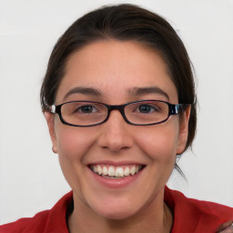 Joyful white young-adult female with medium  brown hair and blue eyes