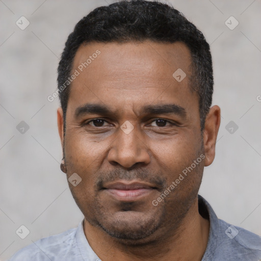 Joyful latino adult male with short  black hair and brown eyes