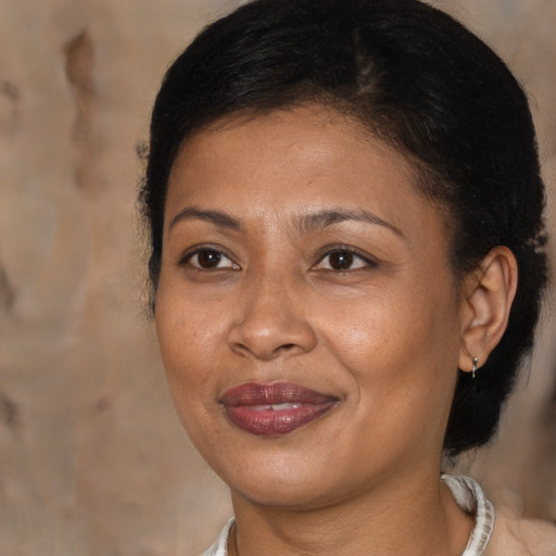 Joyful black adult female with medium  brown hair and brown eyes