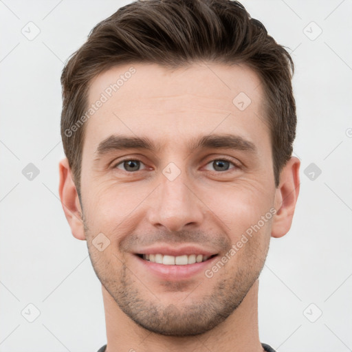 Joyful white young-adult male with short  brown hair and brown eyes