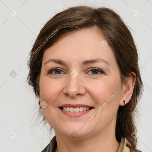 Joyful white adult female with medium  brown hair and grey eyes