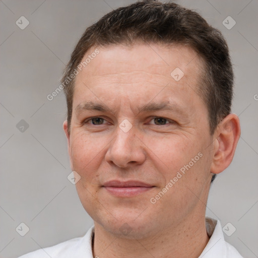 Joyful white adult male with short  brown hair and brown eyes