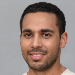 Joyful white young-adult male with short  black hair and brown eyes