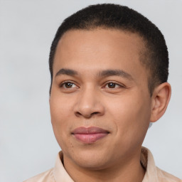 Joyful latino young-adult male with short  brown hair and brown eyes